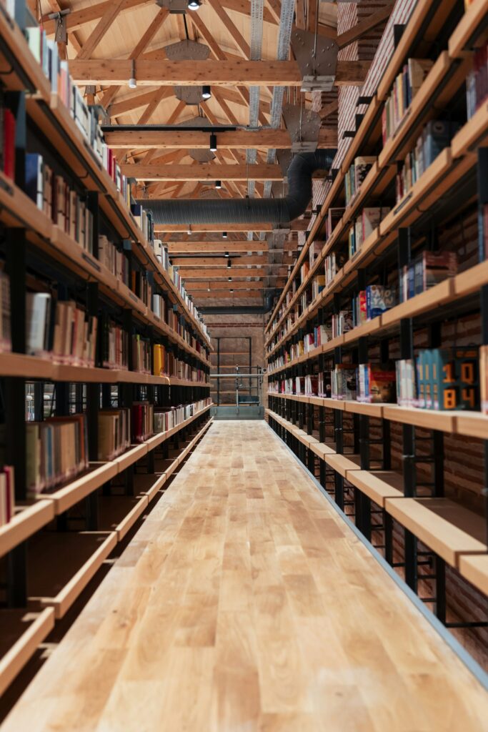 Modern wooden library aisle with long shelves of books